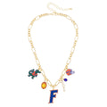 Gold chain necklace with multiple charms, including a large 'F' charm and Gators-themed designs in orange and blue.