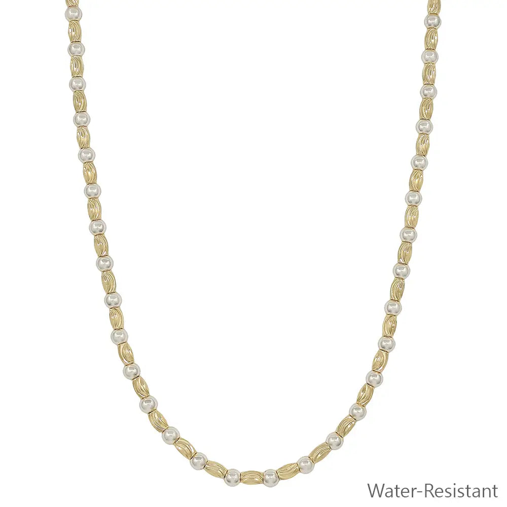 Gold and silver textured necklace featuring an oval pendant and adjustable length, labeled as water-resistant.