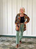 Olive straight-cut jeans styled with a black top and colorful kimono, showcasing an ultra high rise.