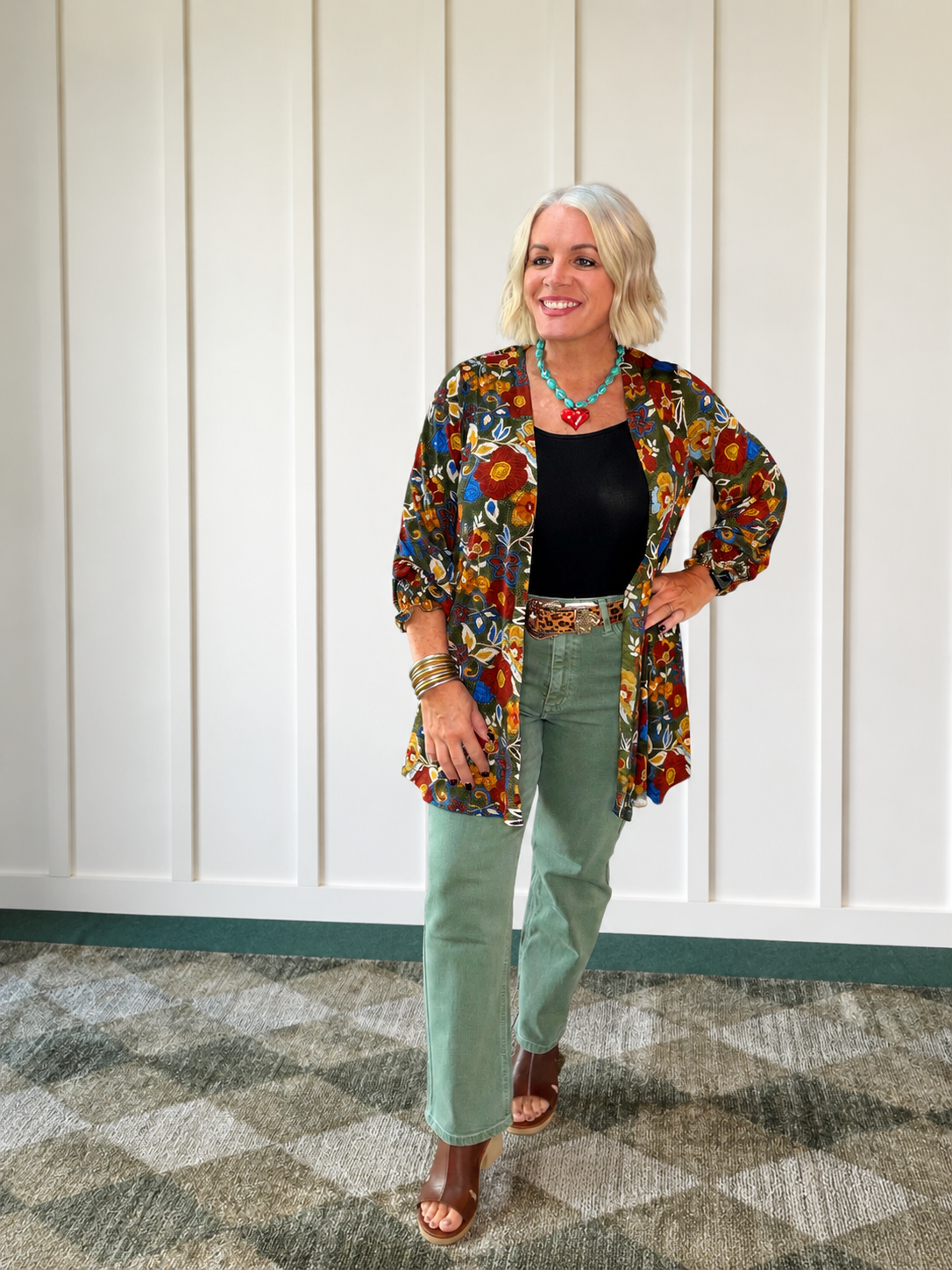 Olive straight-cut jeans styled with a black top and colorful kimono, showcasing an ultra high rise.