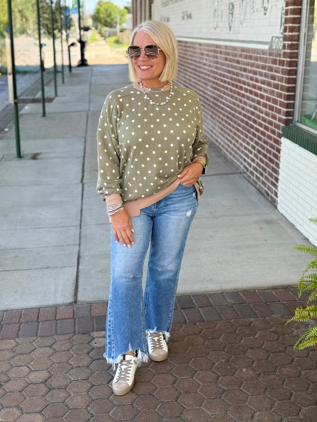 Olive polka dot wave rib top featuring a relaxed fit, drop shoulder silhouette, and triangle cutout detail.