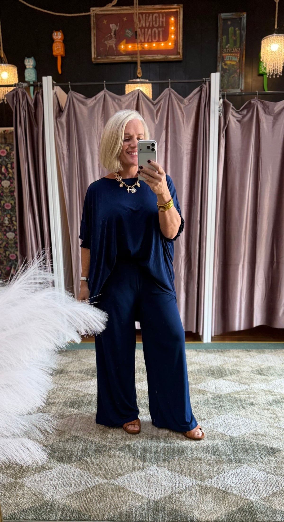 Model wearing a navy 2-piece poncho top and matching pants set in a relaxed, elegant style.