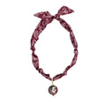 Maroon bandana scarf necklace featuring a tied design and a Seminoles logo charm for versatile wear.