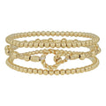 Set of three gold bracelets featuring oval-shaped beads and linked designs from Spunky Sparrow Boutique.