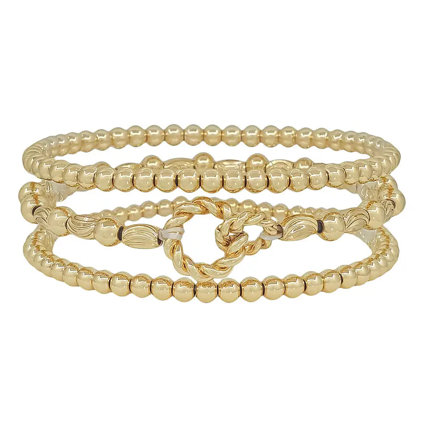 Set of three gold bracelets featuring oval-shaped beads and linked designs from Spunky Sparrow Boutique.