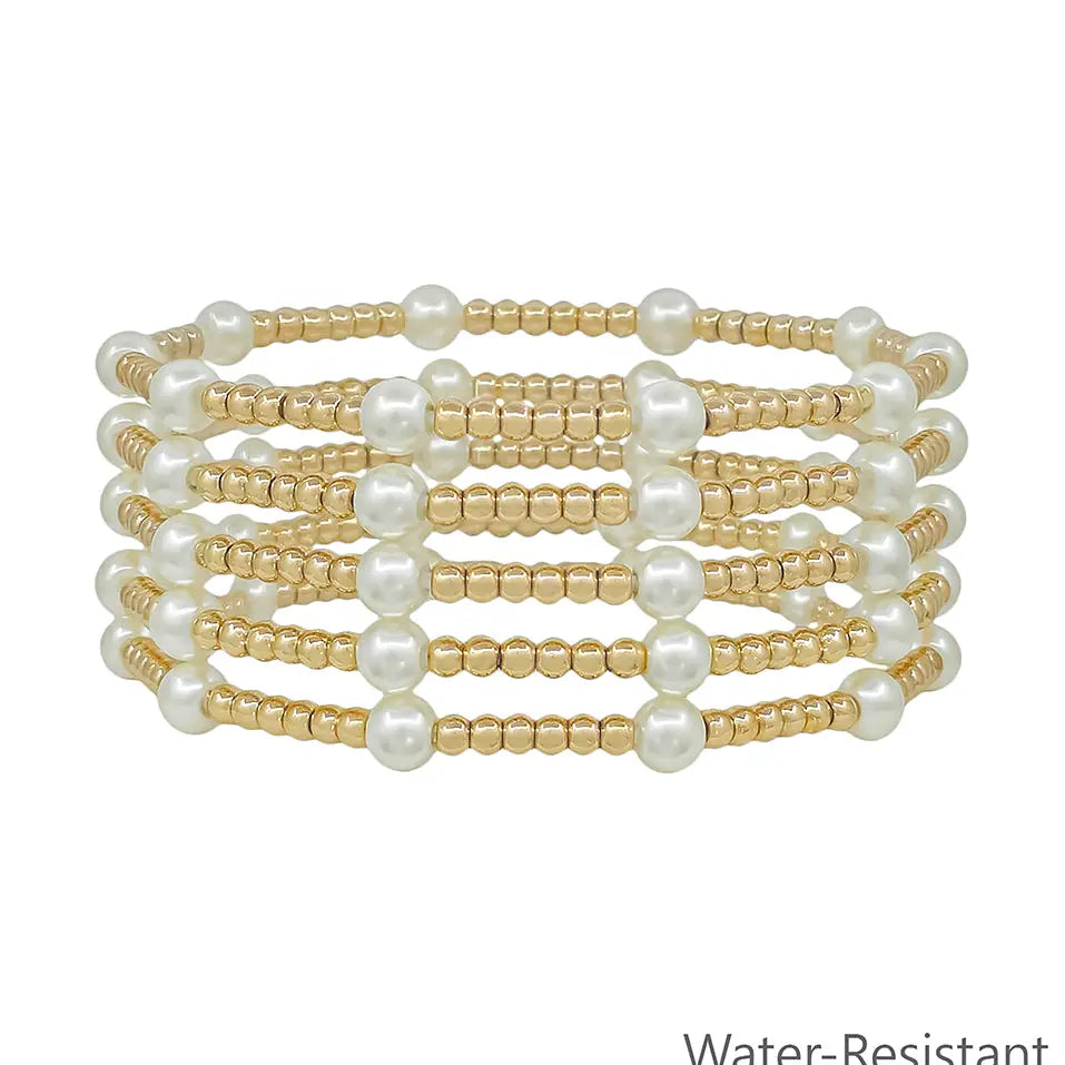 Set of five stacked stretch bracelets featuring alternating pearl beads and smaller beads.