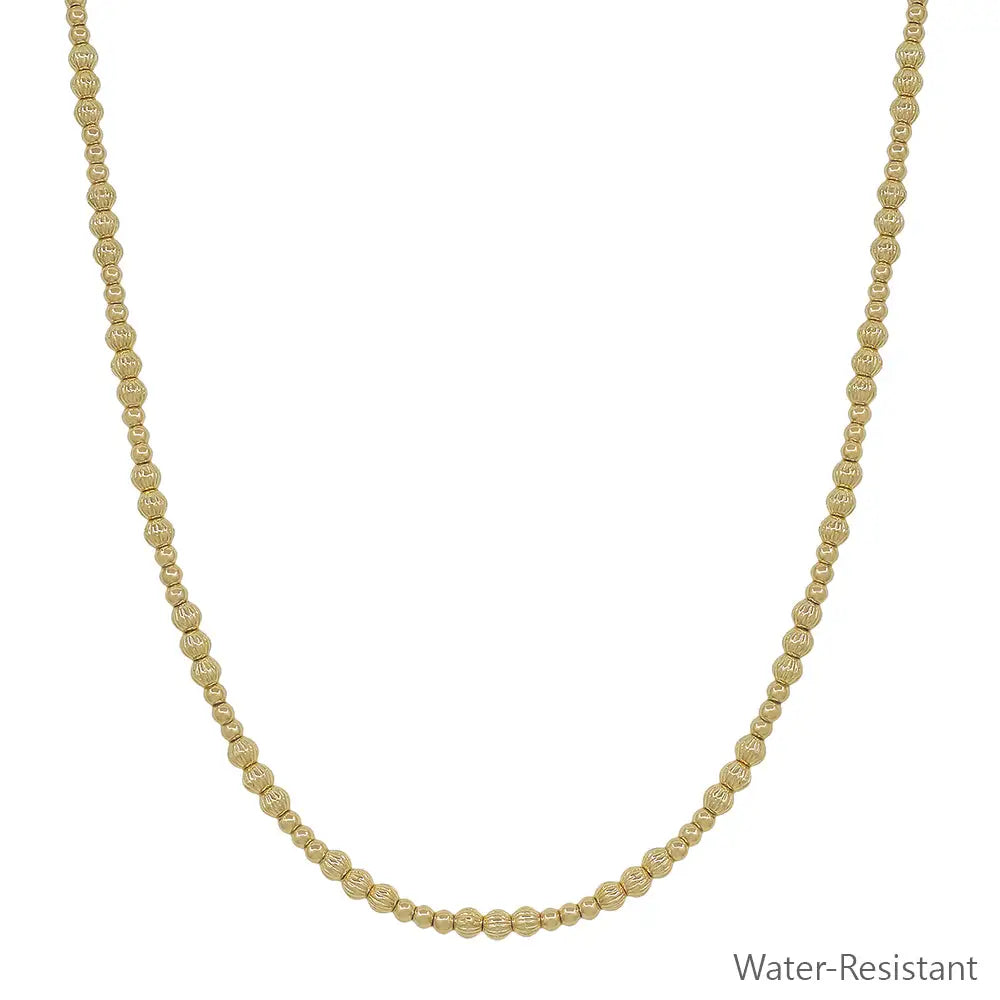 Gold beaded necklace featuring alternating 3mm and 4mm beads with adjustable length from 16 to 18 inches.
