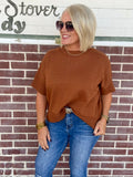 Drop sleeve caramel sweater worn with blue jeans, featuring a crew neck and half sleeves.