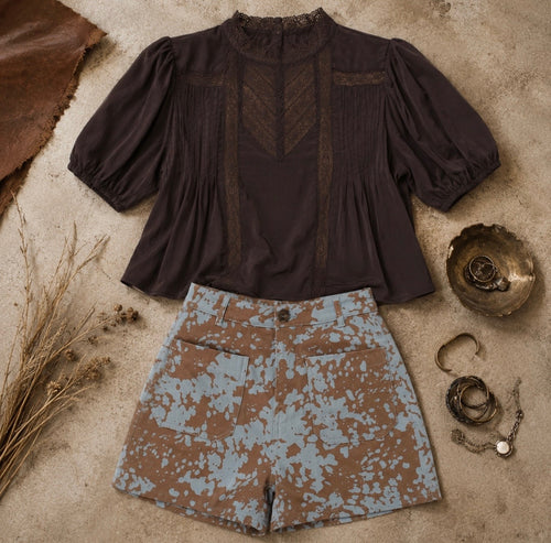 Brown cropped top with lace trim, puff sleeves, and pintuck details, perfect for casual or dressed-up occasions.