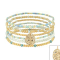 Set of six stretch bracelets featuring turquoise seed beads, white beads, gold accents, and cross charms.