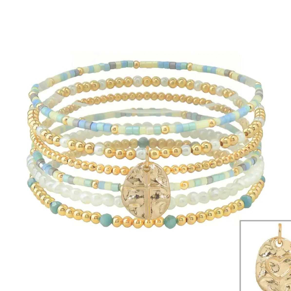 Set of six stretch bracelets featuring turquoise seed beads, white beads, gold accents, and cross charms.