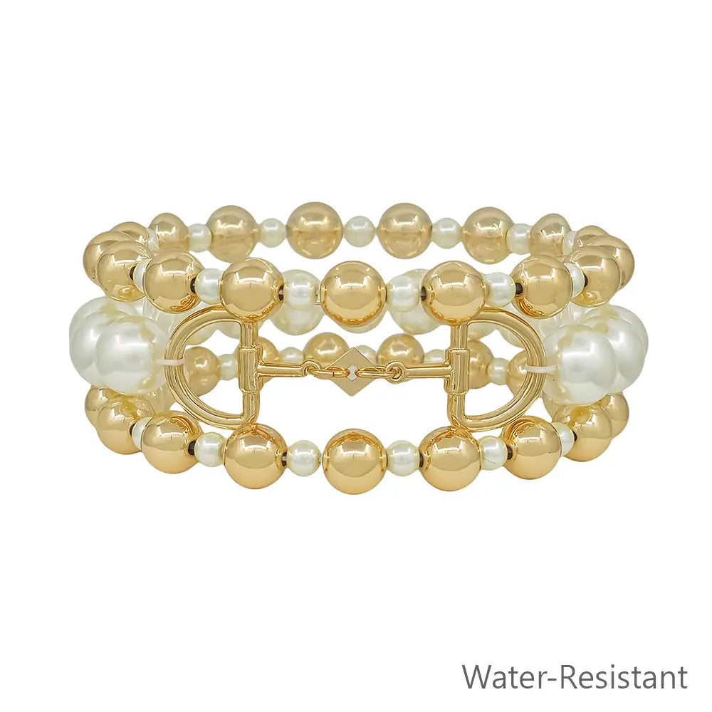 Stretch bracelets with gold-tone and pearl-like beads, featuring a horse bit charm and water-resistant design.